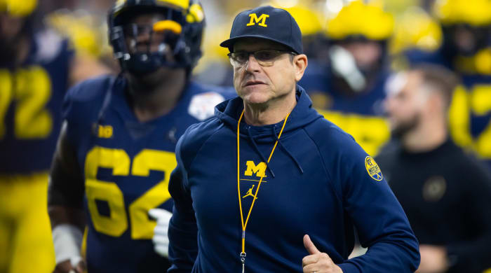 Michigan head coach Jim Harbaugh looks on before a game against TCU in the 2022 Fiesta Bowl.
